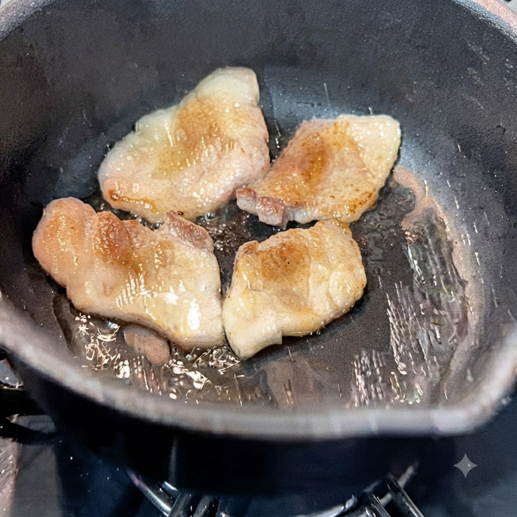Water being poured into the hot pot containing pan-fried pork belly slices.