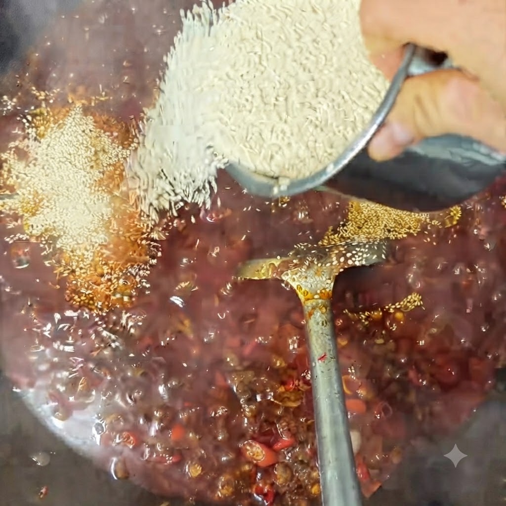 White sesame seeds being sprinkled into the bubbling sauce in a wok.