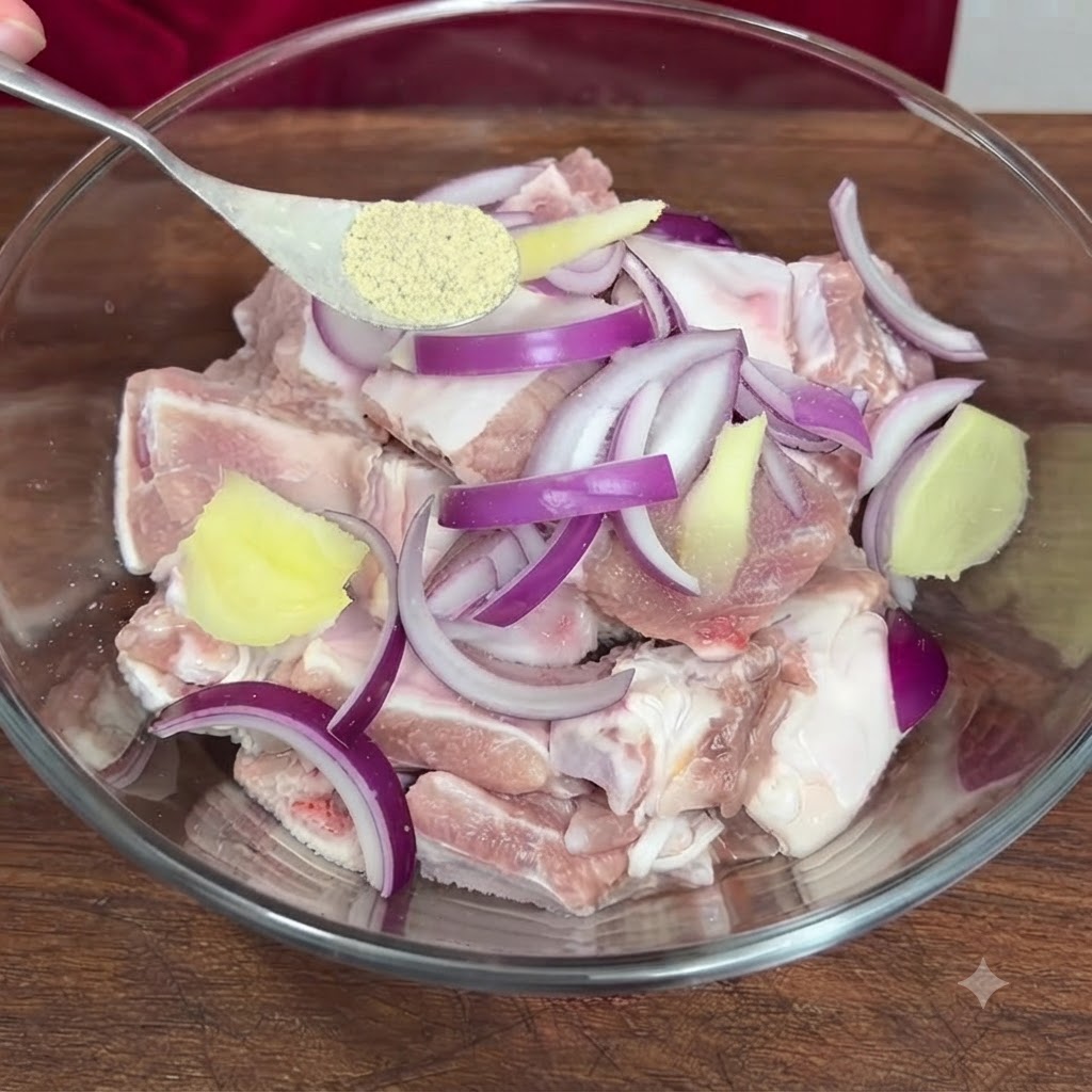 A spoon holding pepper powder being added into the bowl containing the seasoned pork ribs.