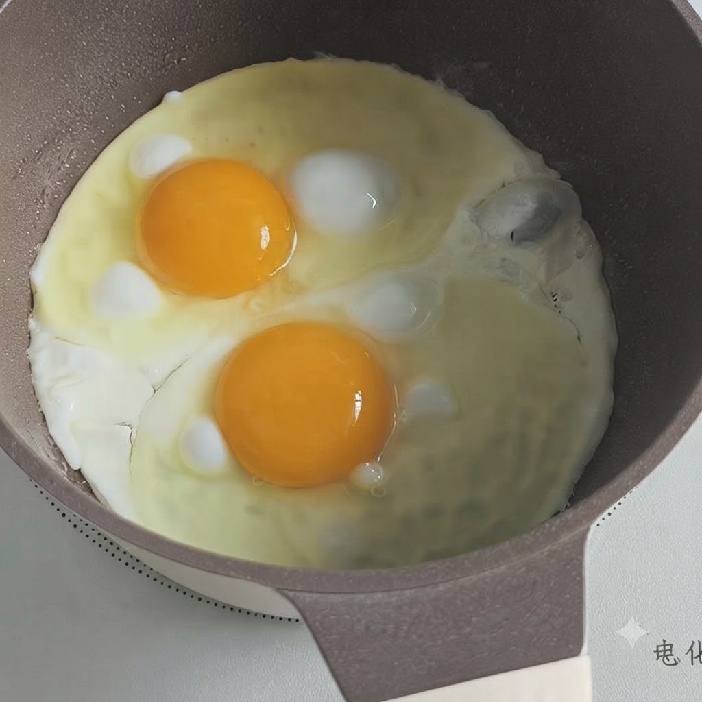 Two sunny-side up eggs frying in a cooking pot with the edges beginning to set.