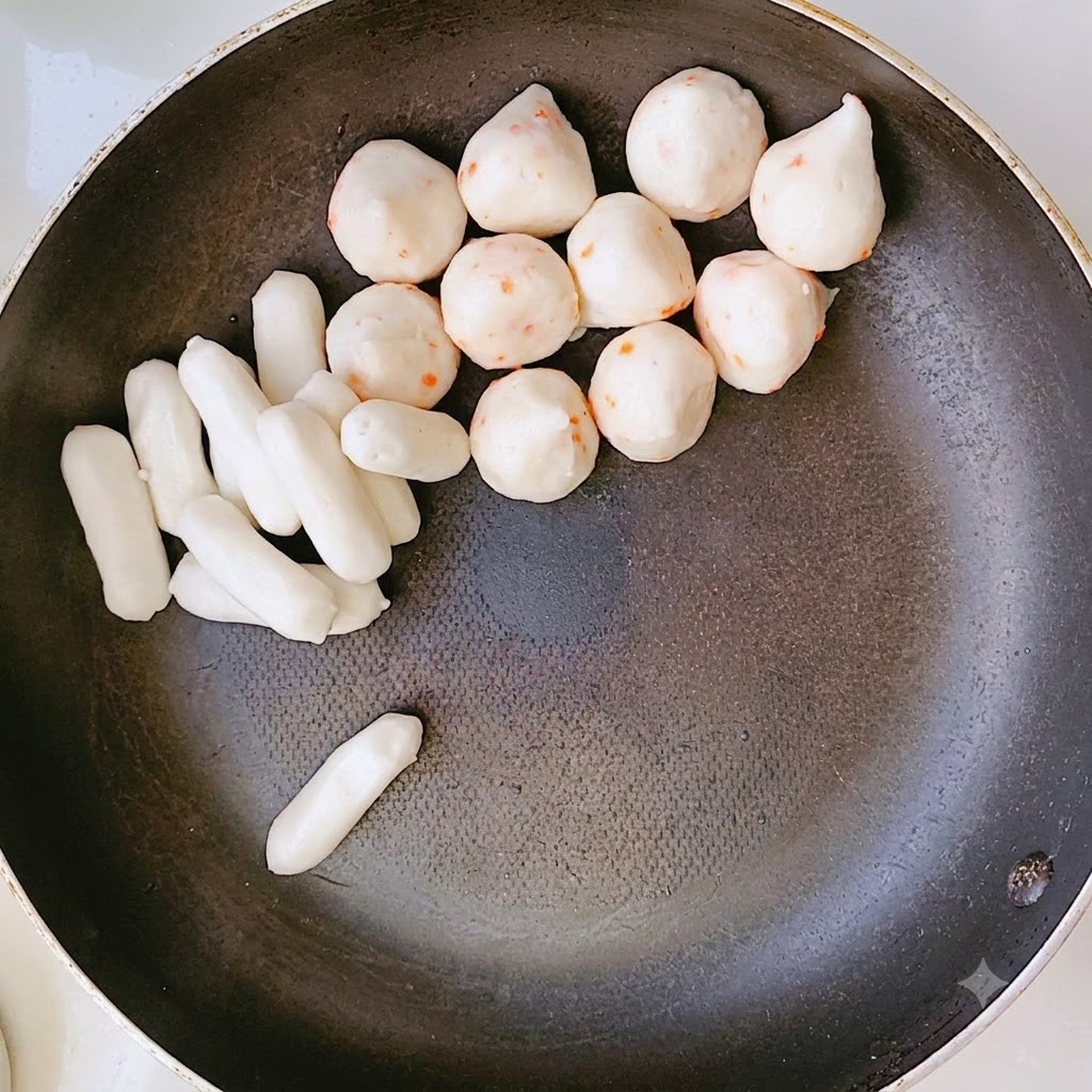 A pan filled with arranged layers of rice cakes and other ingredients