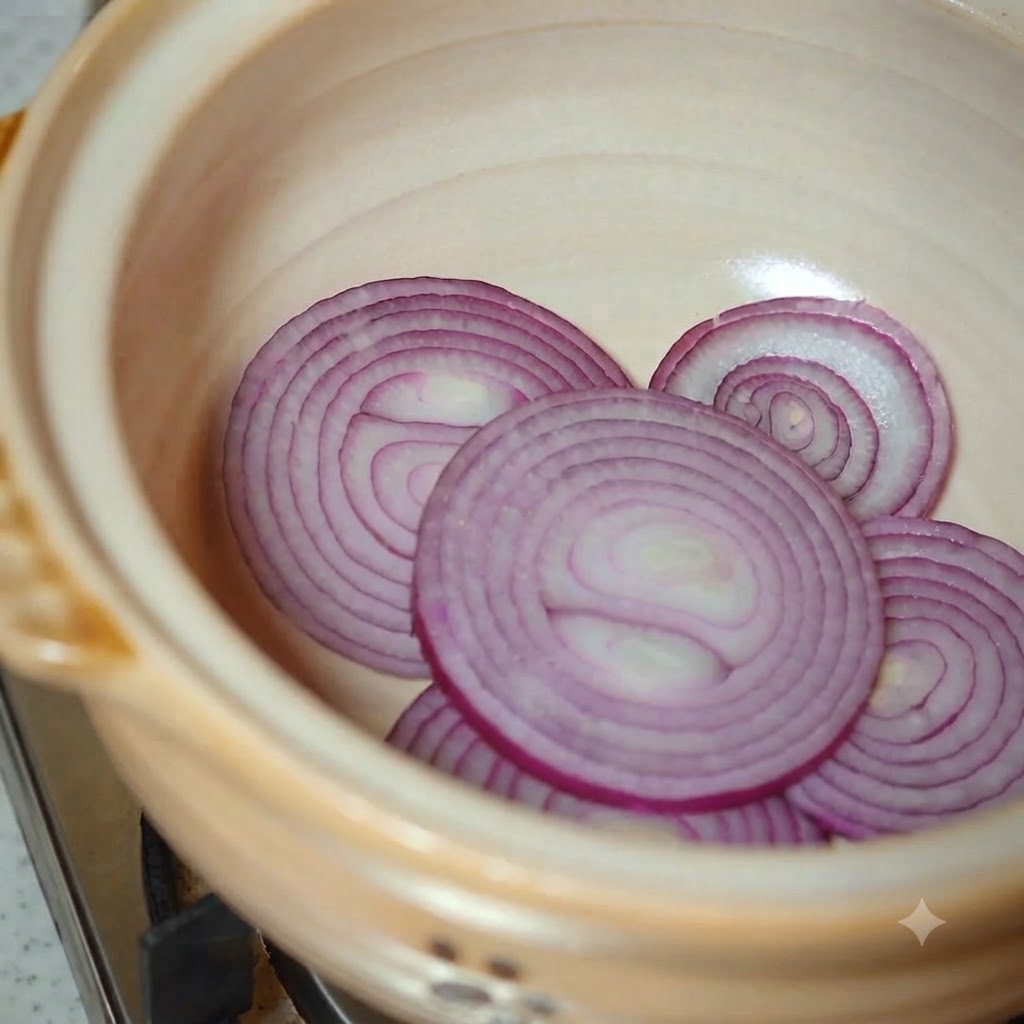 Napa cabbage and sliced zucchini being added to the earthenware pot.
