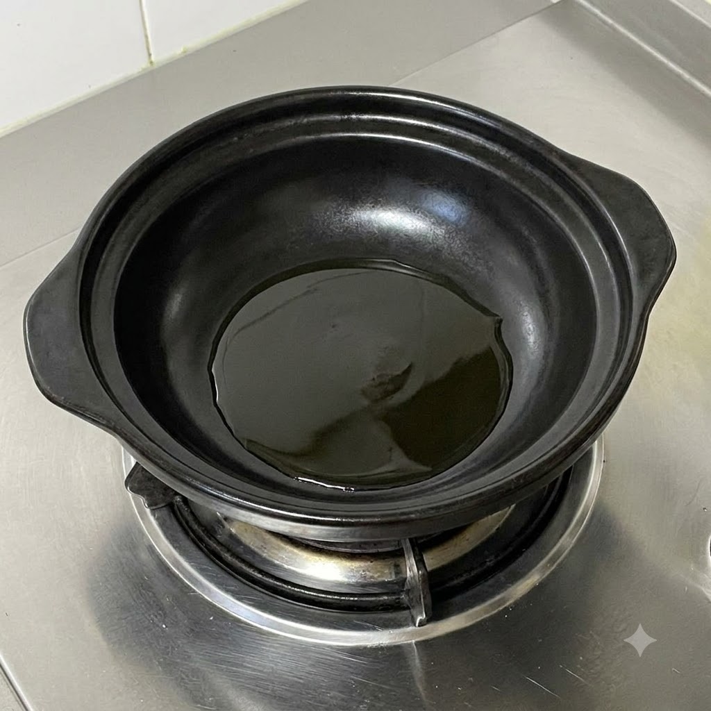 Chopped green onions sizzling in hot oil inside a black ceramic pot.