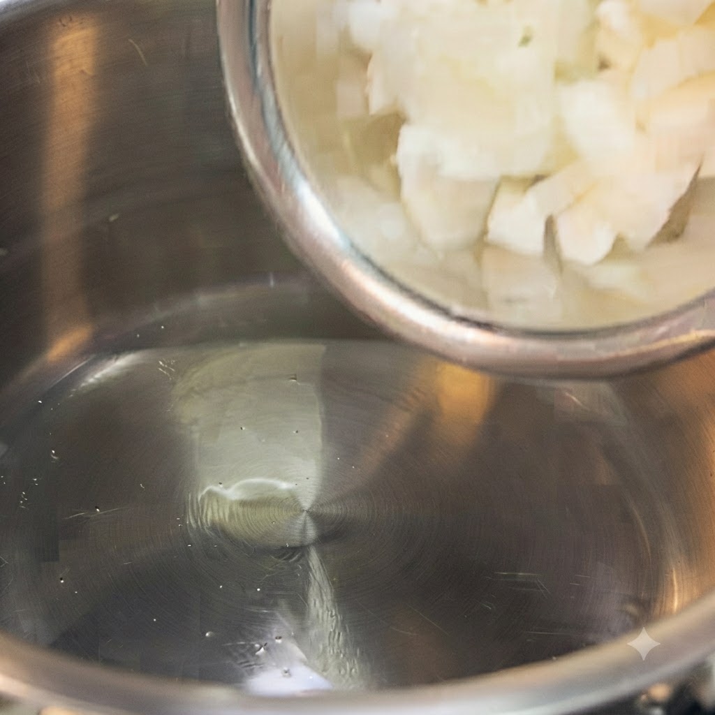 Diced onions, potatoes, and carrots being stir-fried in a stainless steel pot.