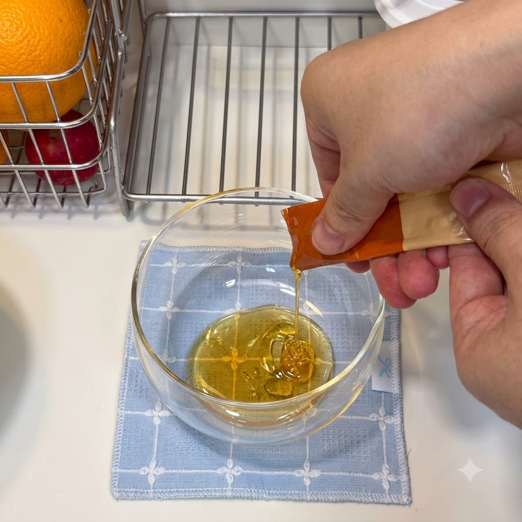 Honey and sauces being poured into a clear glass bowl to mix the glaze.