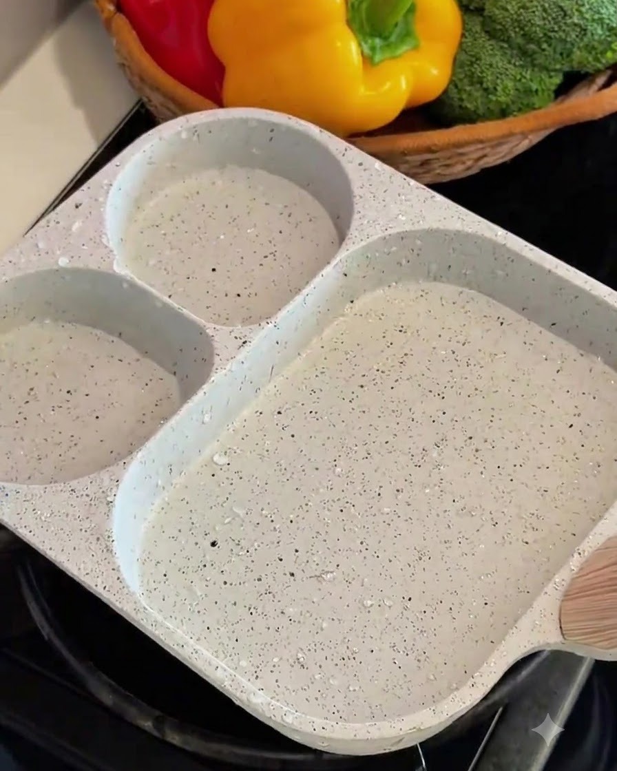 Beaten egg being poured and rolled into layers in a square pan.