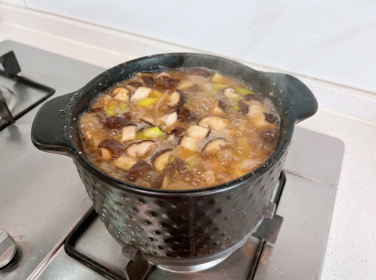Cubed white tofu simmering inside the flavorful Doenjang Jigae broth.