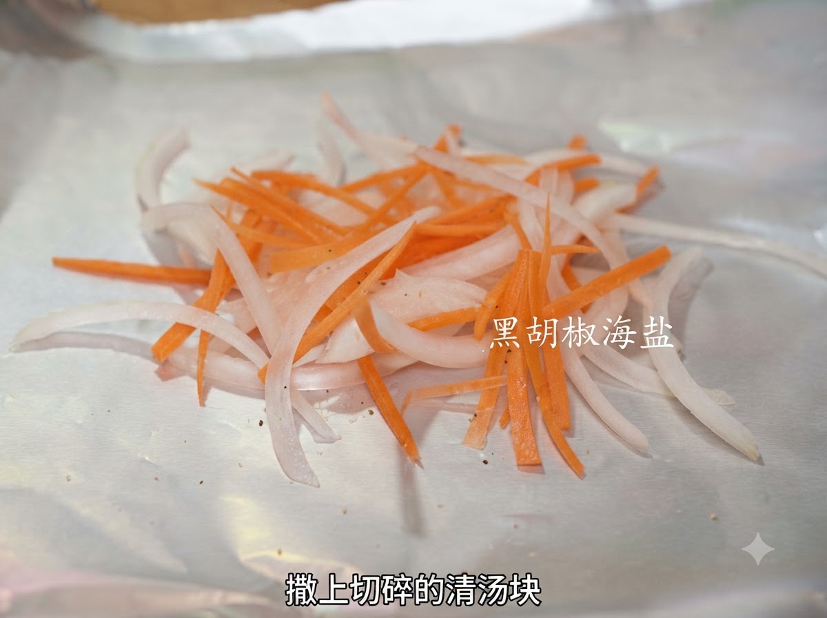 Crushed bouillon pieces sprinkled over a pile of sliced onions and carrots on aluminum foil.